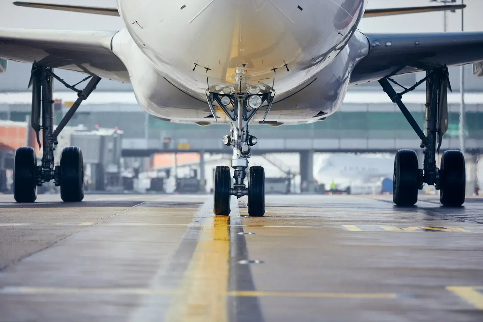 Front view of airplane landing gear on a runway